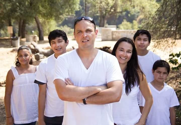 Family of 6 with white shirts all posing with dad in front, arms crossed. All have Keratoconus.