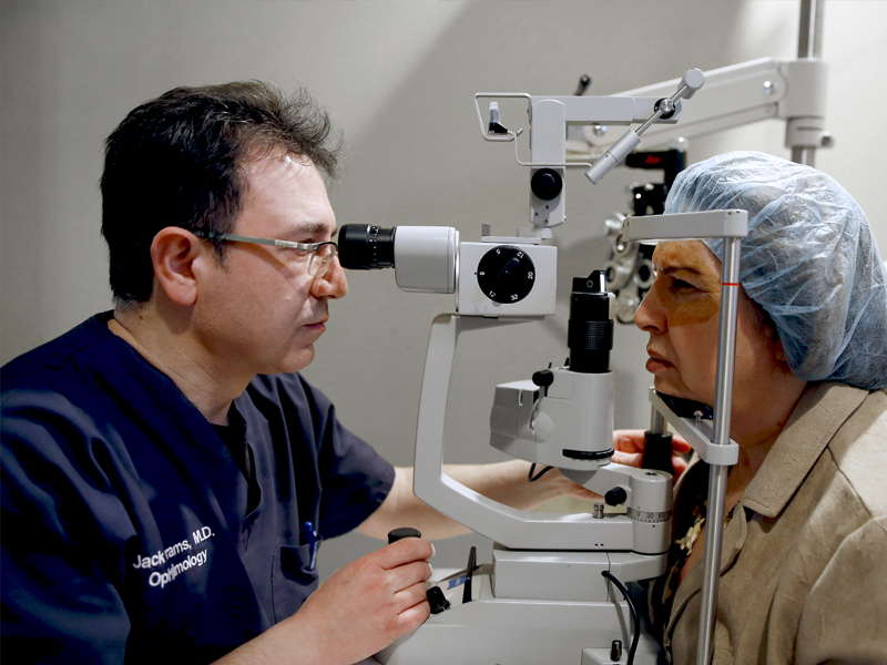 Dr. Abrams using a slit lamp to examine the inner workings of the eye of a real patient.