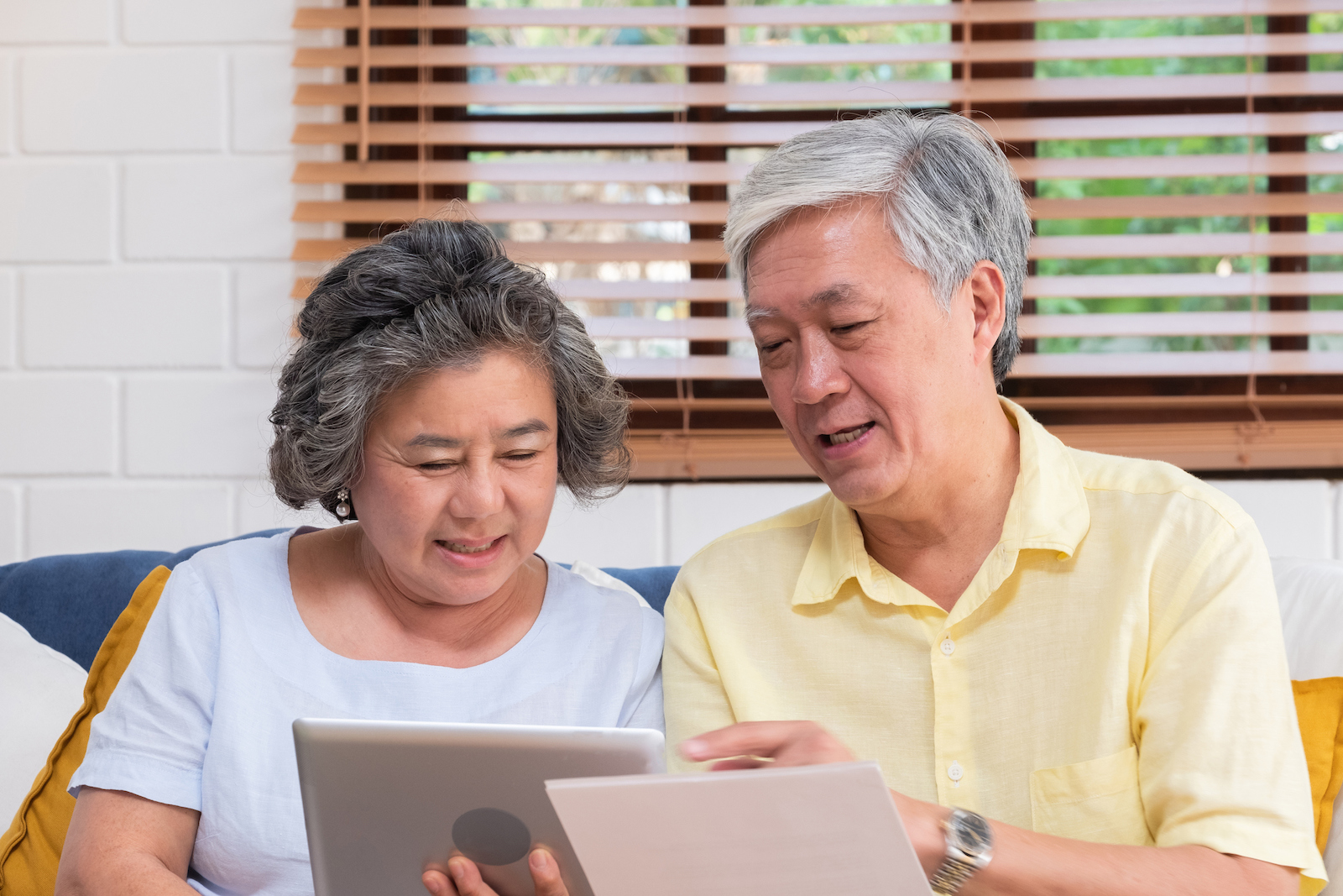 Woman and man reviewing information about Cataract Surgery expectations on tablet.