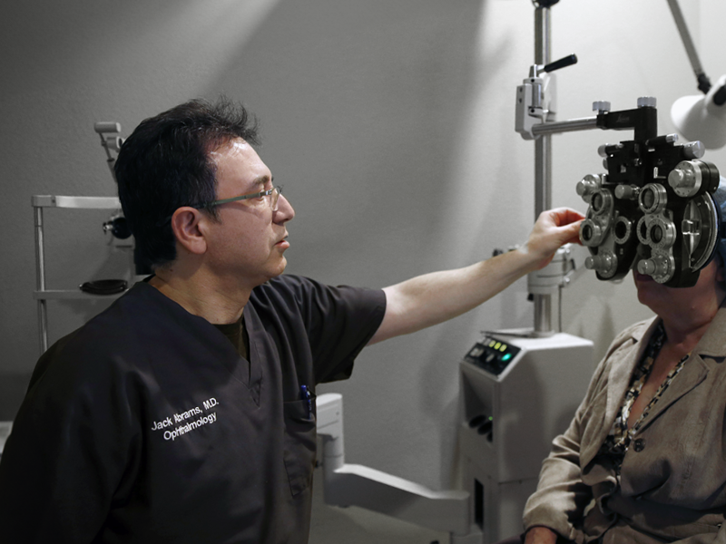 Dr. Abrams running an optical examination determining corrective lens prescription for a patient